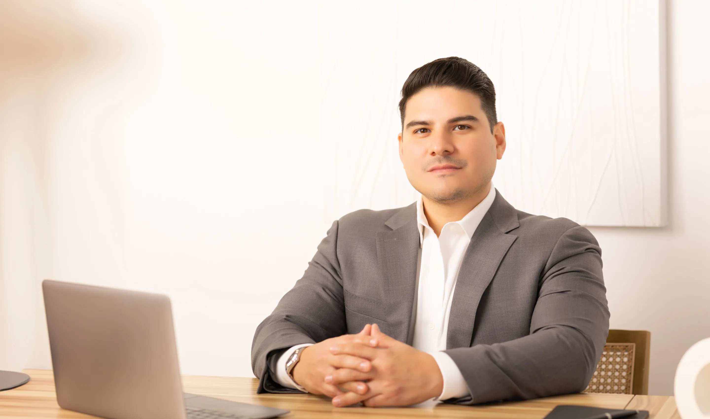 George Orellana, managing attorney at Orellana Law, seated at his desk