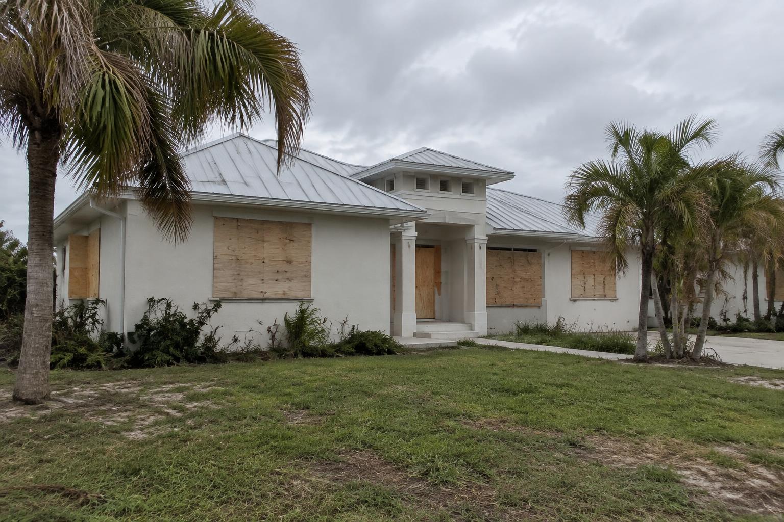 A Florida home with boarded windows after storm damage supporting a hurricane insurance claim