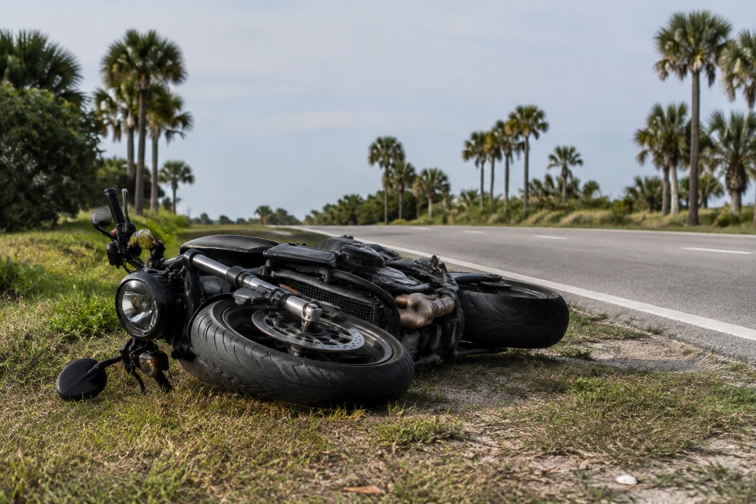 Motorcycle involved in an accident resting on a Miami roadway during daylight hours