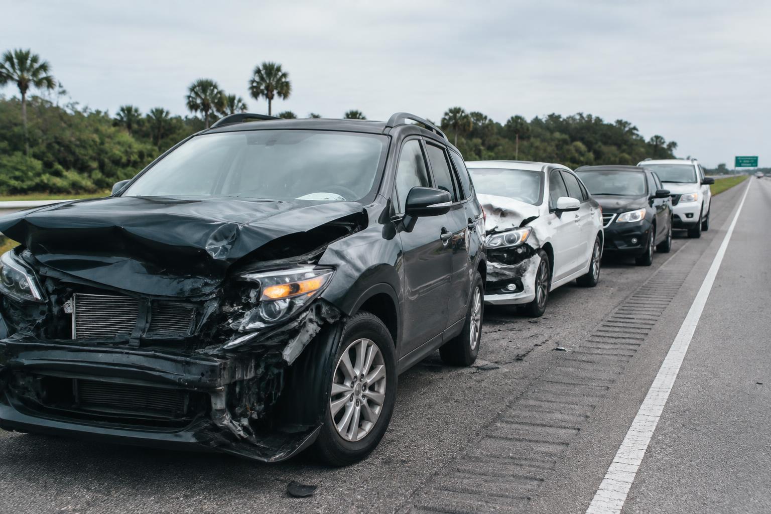 Multiple damaged vehicles along a Florida highway after a multi-vehicle accident