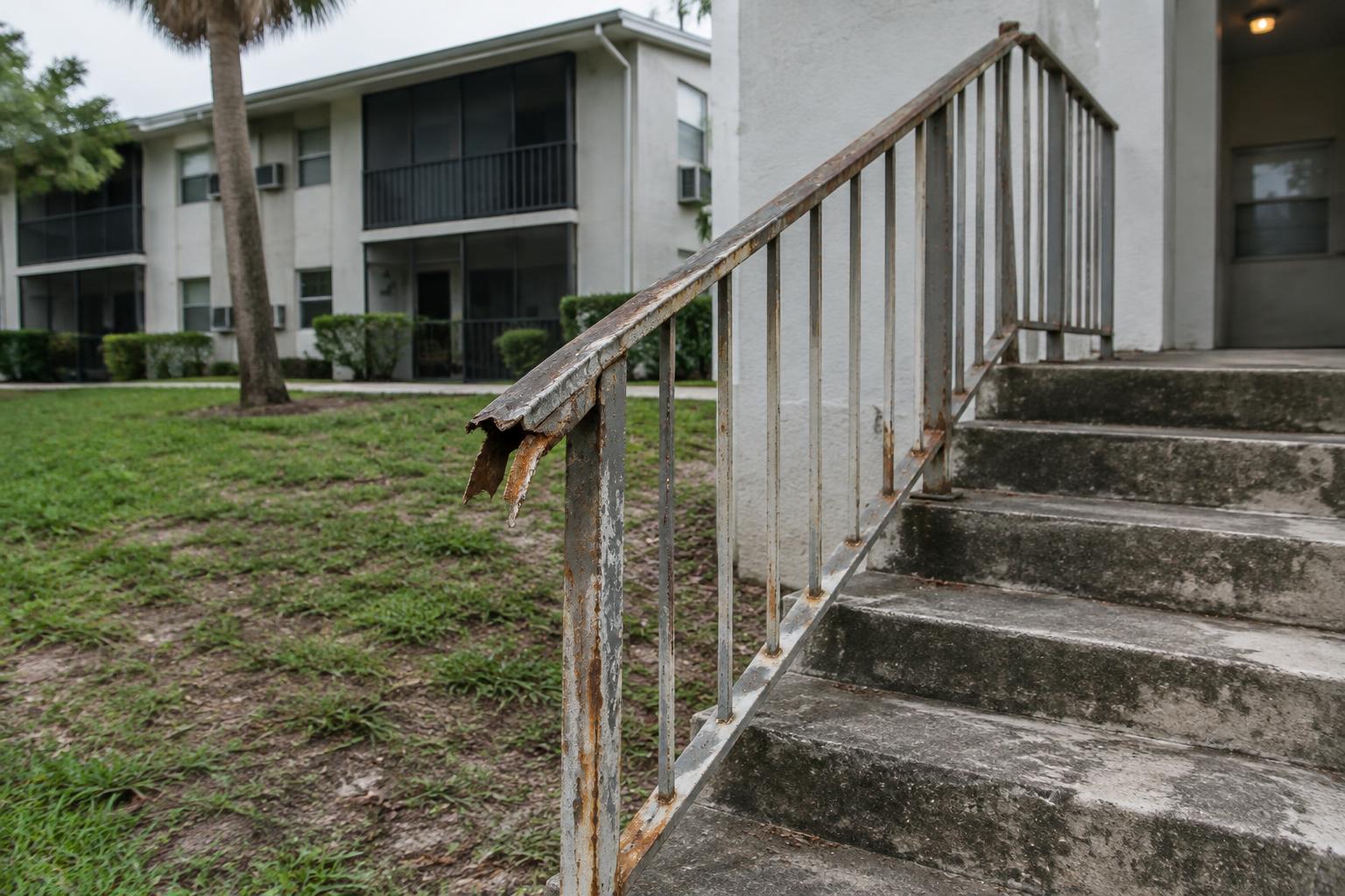 A broken handrail illustrates an unsafe property condition relevant to a premises liability claim.